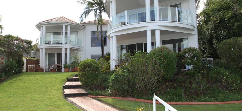 Large house on a hill with a pathway leading up to it